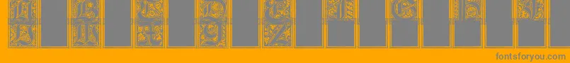 Fonte CamelotInitials – fontes cinzas em um fundo laranja