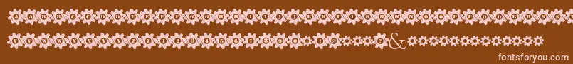 フォントStuckedInGears – 茶色の背景にピンクのフォント