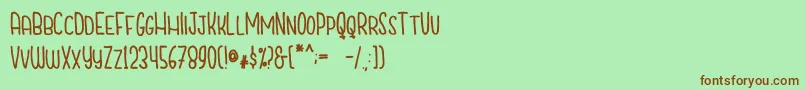 CutiescapsFree-fontti – ruskeat fontit vihreällä taustalla