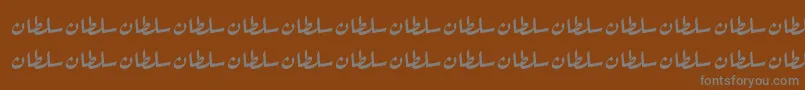 SultanNormal-fontti – harmaat kirjasimet ruskealla taustalla