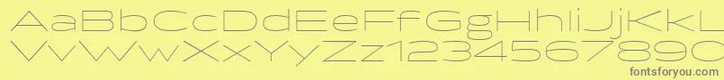 フォントBrillerThin – 黄色の背景に灰色の文字