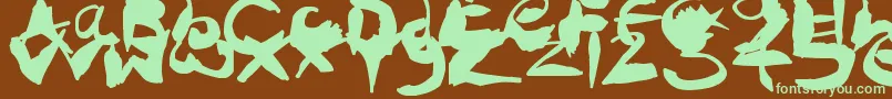 フォントCrazyInkSplats – 緑色の文字が茶色の背景にあります。