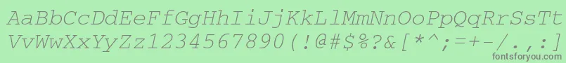 CouriercttOblique-fontti – harmaat kirjasimet vihreällä taustalla