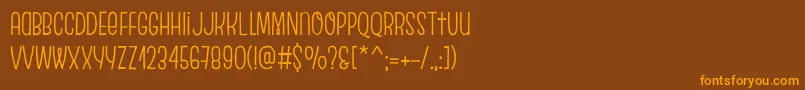 フォントEscalopeCrustTwo – オレンジ色の文字が茶色の背景にあります。