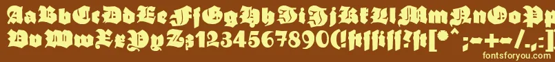 Ganzgrobegotisch-fontti – keltaiset fontit ruskealla taustalla