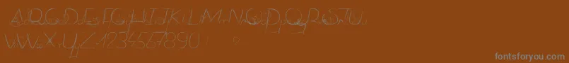 DancingOnTheGrass-Schriftart – Graue Schriften auf braunem Hintergrund