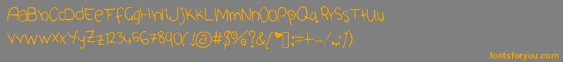 フォントCuteFont – オレンジの文字は灰色の背景にあります。