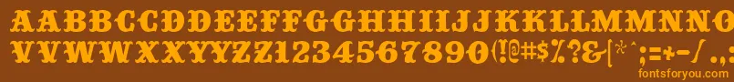 フォントBig Top – オレンジ色の文字が茶色の背景にあります。