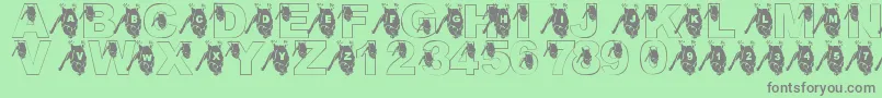 LmsGoingBatty-Schriftart – Graue Schriften auf grünem Hintergrund