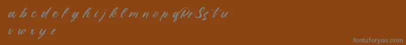 RufflescriptDemo-Schriftart – Graue Schriften auf braunem Hintergrund