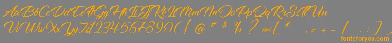 DancingInTheRainbow-Schriftart – Orangefarbene Schriften auf grauem Hintergrund