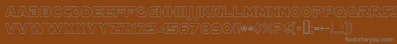 DistantGalaxyOutline-Schriftart – Graue Schriften auf braunem Hintergrund