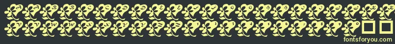 Fonte LcrFlowersFromMyHeart – fontes amarelas em um fundo preto