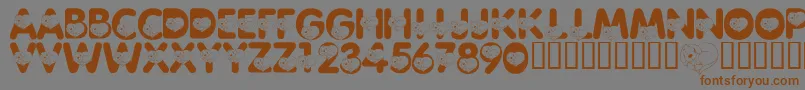 フォントLmsCliffordTheBigRedFont – 茶色の文字が灰色の背景にあります。
