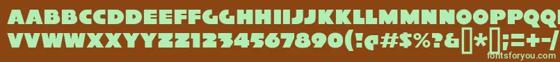 フォントXylitolSolo – 緑色の文字が茶色の背景にあります。