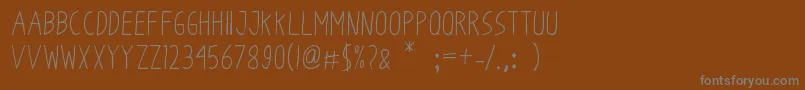 フォントOdumOdum – 茶色の背景に灰色の文字