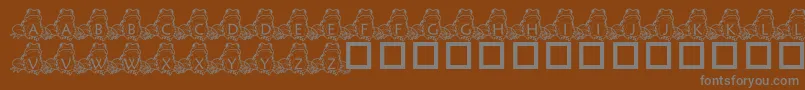 PfFrogSitting-fontti – harmaat kirjasimet ruskealla taustalla