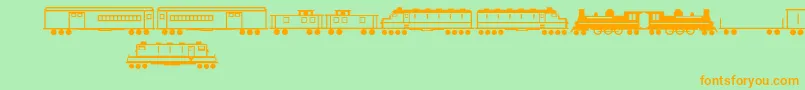 フォントTrains – オレンジの文字が緑の背景にあります。