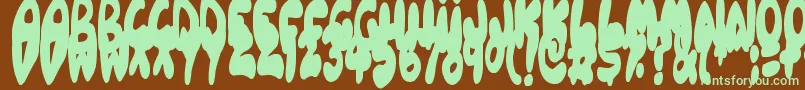 フォントBalloonish – 緑色の文字が茶色の背景にあります。