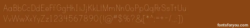フォントPrintDashedTt – 茶色の背景に白い文字