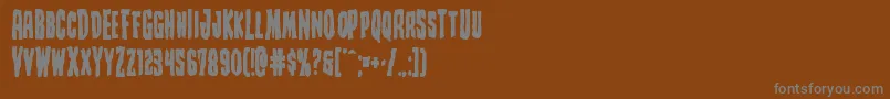 Creepycrawlersbold-Schriftart – Graue Schriften auf braunem Hintergrund