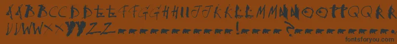 フォントCollateraldamage – 黒い文字が茶色の背景にあります