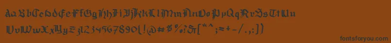 Mousefraktur Font – Black Fonts on Brown Background