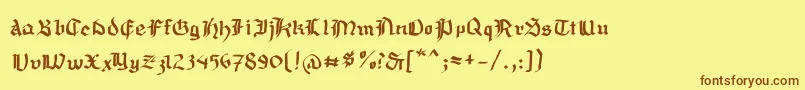 フォントMousefraktur – 茶色の文字が黄色の背景にあります。