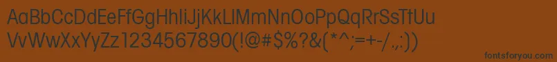 フォントAvignonCdRegular – 黒い文字が茶色の背景にあります