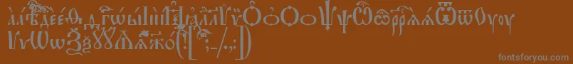 IrmologionIeucs-fontti – harmaat kirjasimet ruskealla taustalla
