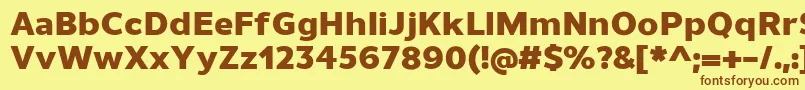 フォントUnimanHeavy – 茶色の文字が黄色の背景にあります。