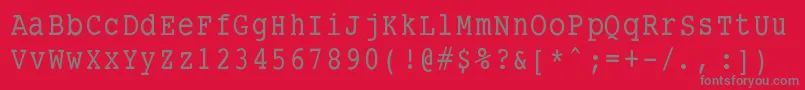 Smalltypewritingmedium-fontti – harmaat kirjasimet punaisella taustalla