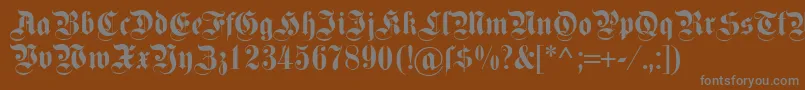 Dsfettekanzlei-fontti – harmaat kirjasimet ruskealla taustalla