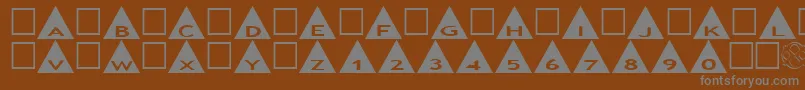 Czcionka AlphashapesTriangles – szare czcionki na brązowym tle