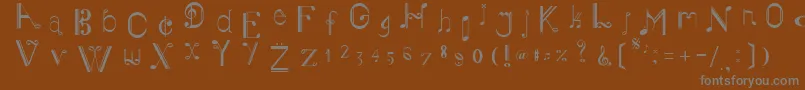 MusikerSingle-fontti – harmaat kirjasimet ruskealla taustalla