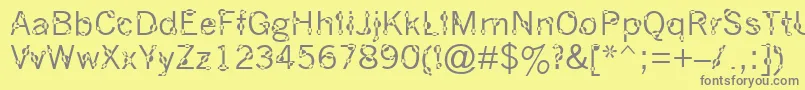 DotYourEyes-fontti – harmaat kirjasimet keltaisella taustalla