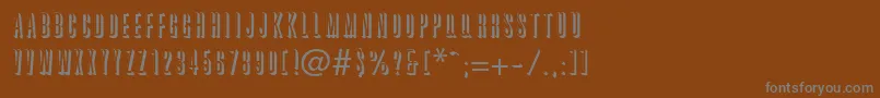 GraphiteRegularDb-fontti – harmaat kirjasimet ruskealla taustalla