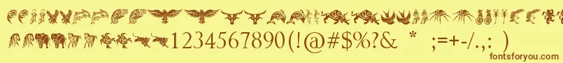 Шрифт TribalAnimalsTattooDesigns – коричневые шрифты на жёлтом фоне