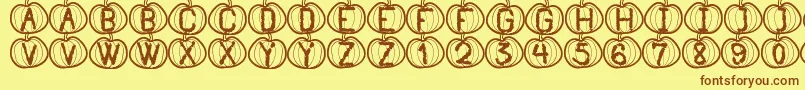 Fonte PumpkinHalloweenSt – fontes marrons em um fundo amarelo