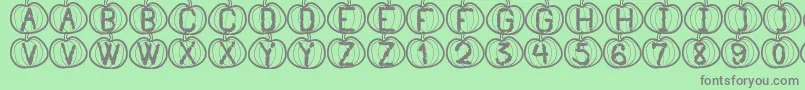 Fonte PumpkinHalloweenSt – fontes cinzas em um fundo verde