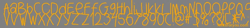 フォントBigwriter – オレンジの文字は灰色の背景にあります。
