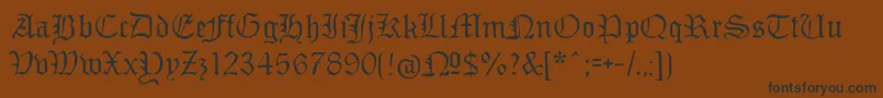 フォントMonamourfraktur – 黒い文字が茶色の背景にあります