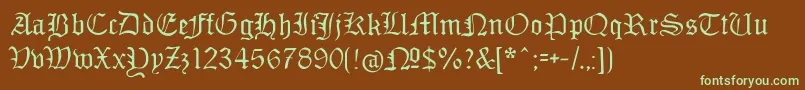 フォントMonamourfraktur – 緑色の文字が茶色の背景にあります。