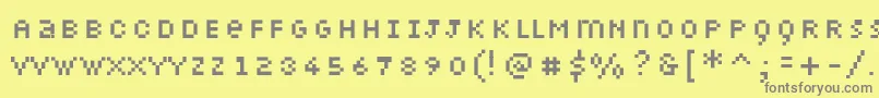 Petiote-fontti – harmaat kirjasimet keltaisella taustalla