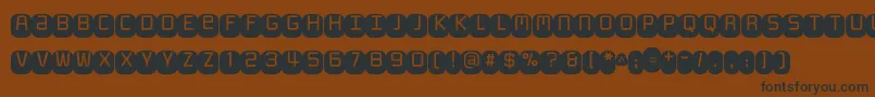 Monofett Font – Black Fonts on Brown Background