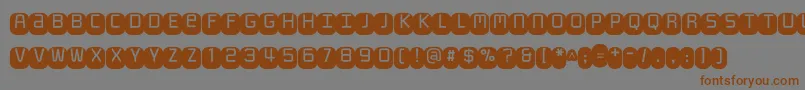 Monofett Font – Brown Fonts on Gray Background