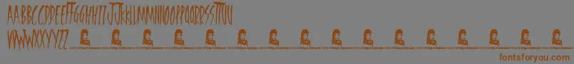 フォントFreedomFighters – 茶色の文字が灰色の背景にあります。
