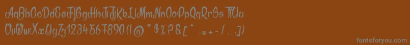 フォントAkodia – 茶色の背景に灰色の文字