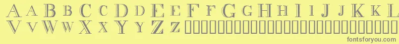 フォントDecnodi – 黄色の背景に灰色の文字