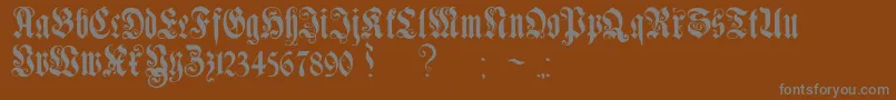 GenzschEtHeyseAlternate-fontti – harmaat kirjasimet ruskealla taustalla